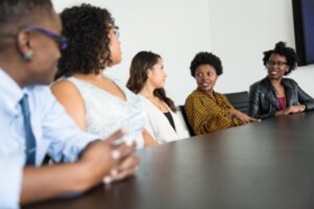 DEI metrics employees at a conference table