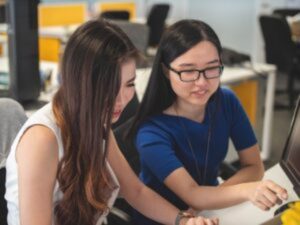 Two women working together.