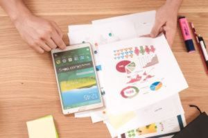 Planning on a table with iPad and charts.