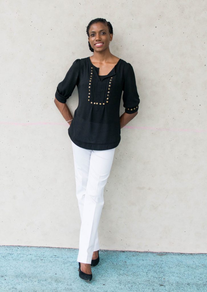 Marie Deveaux Marie Deveaux is leaning against an outside wall, smiling at you.